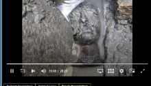 screenshot of OU podcast site - in the centre is a photograph of a bronze votive head, partially submerged in mud.